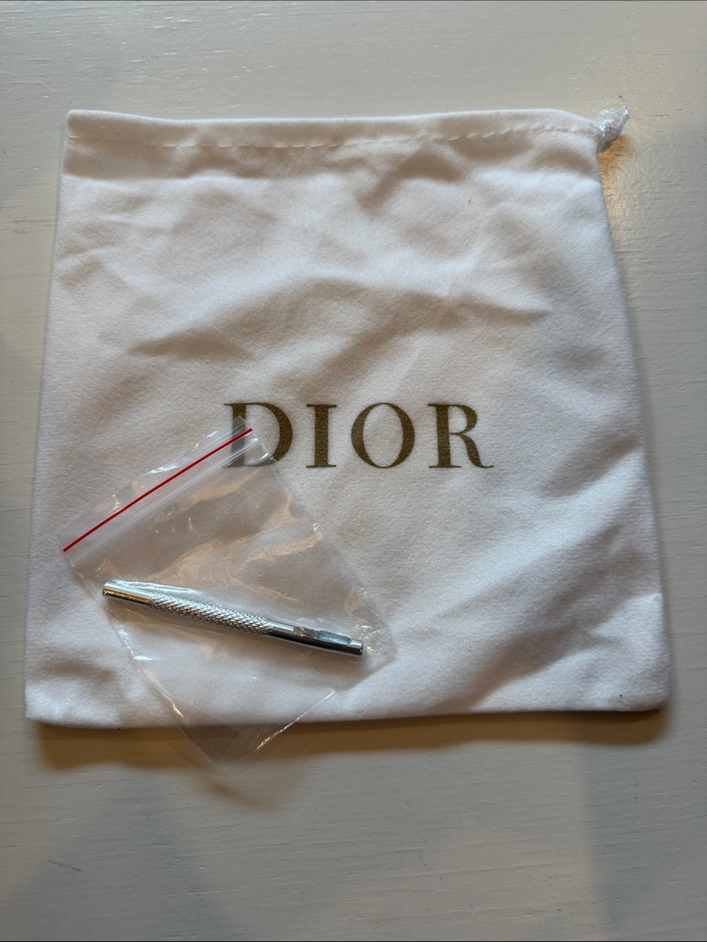 Dior White Drawstring Pouch with Gold Logo and Silver Tool